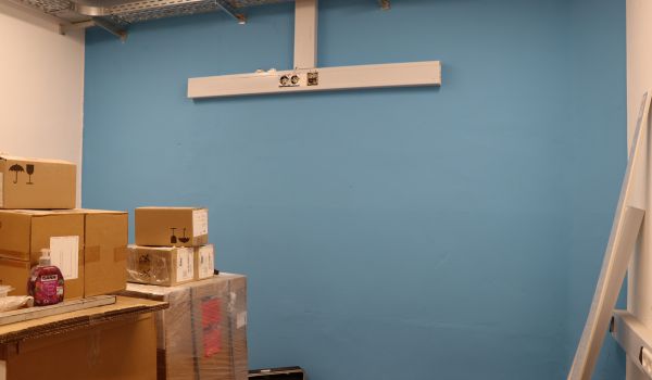 Kartons stehen vor einer blauen Wand.
