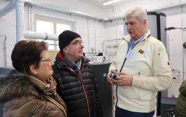 Zwei Männer und eine Frau unterhalten sich bei der Ausstellung.