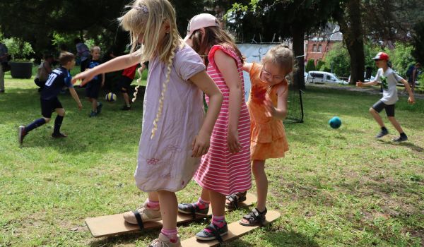 Kinder spielen auf einer Wiese.